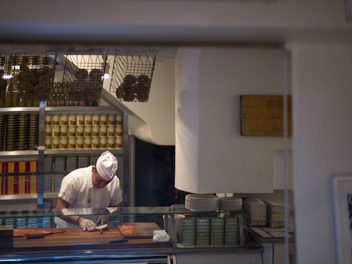 A man stands behind the counter at Russ and Daughters Cafe.