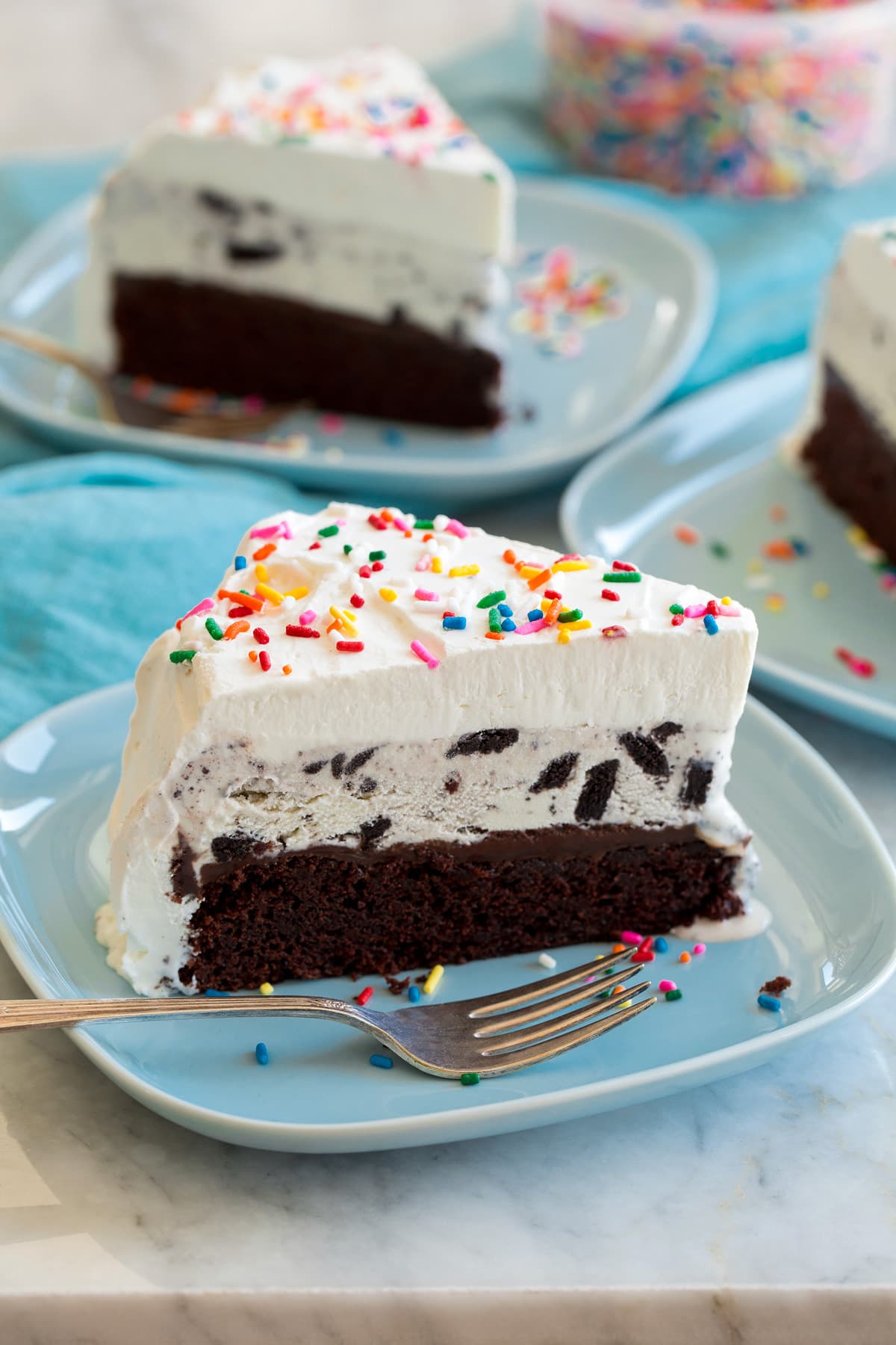 Ice cream cake with chocolate cake, fudge sauce, cookies and cream ice cream and whipped cream topping.