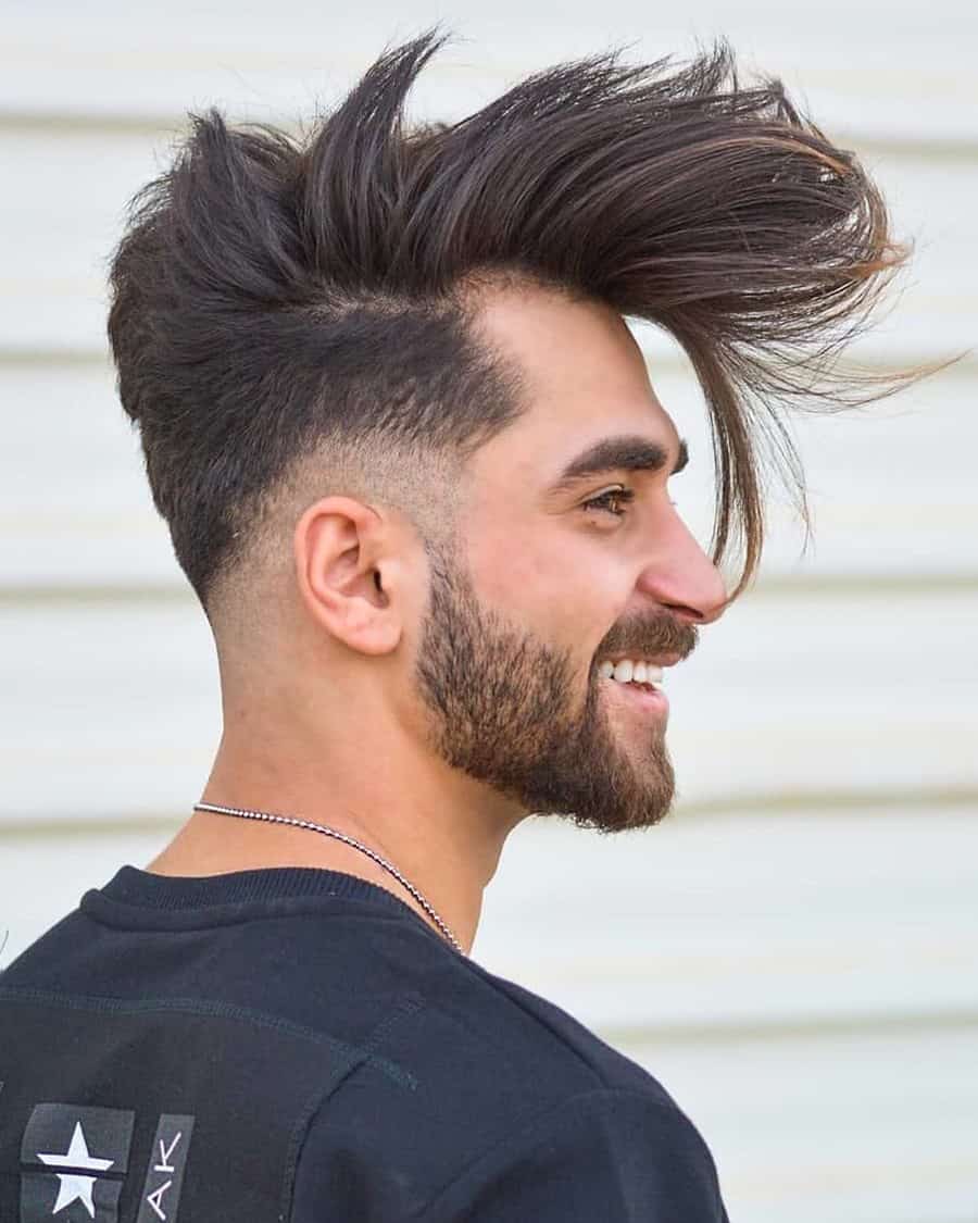 Men's long extreme pompadour haircut with low fade
