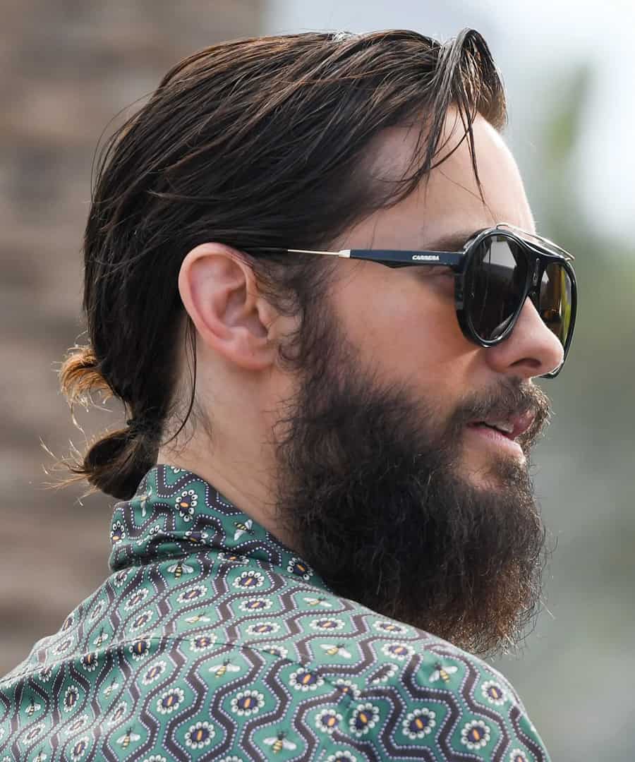 Modern men's long hair tied back into ponytail