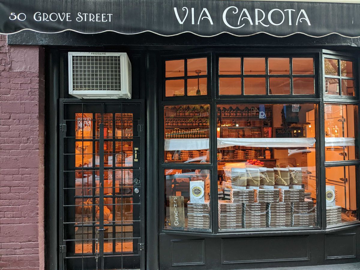 The image features a storefront sign displaying the name Via Carota, along with the address 50 Grove Street.