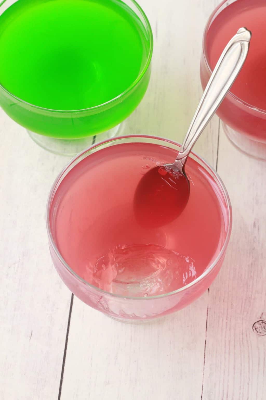 Vegan Jello in fun and fruity red and green colors in glass dishes.