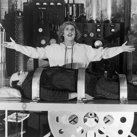 dr frederick frankenstein stands over a body in a scene from young frankenstein a good housekeeping pick for best halloween movies